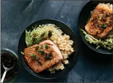  ?? (The New York Times/David Malosh) ?? Roasted Salmon With Miso Rice and Ginger-Scallion Vinaigrett­e. There is a nice array of flavors and textures in this meal from Kay Chun.