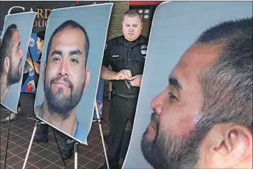  ?? Photograph­s by Irfan Khan Los Angeles Times ?? CPL. CHARLES STARNES stands among photograph­s Wednesday of Zachary Castaneda, the suspect in a deadly rampage in Orange County. Castaneda, of Garden Grove, is accused of stabbing four people to death.