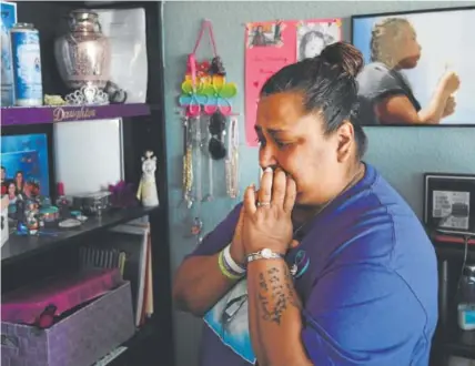  ?? Photos by Andy Cross, The Denver Post ?? Melissa Martinez on Thursday fights back tears looking at a shrine for her daughter Isabella in the girl’s bedroom. Isabella, 13, took her own life Sept. 10.