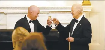  ?? AP photo ?? Utah Gov. Spencer Cox (left) and President Joe
Biden toast before Biden speaks to members of the National Governors Associatio­n during an event in the State Dining Room of the White House in Washington on Saturday.
