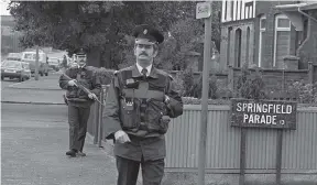  ??  ?? Armed RUC officers on foot patrol in Belfast during the Eighties