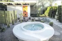  ??  ?? THE EXTERIOR of the 1960 home was updated with pavers, drought-tolerant plants and an outdoor shower, center page, and a fountain, right. The home, by local builder Jack Meiselman, was expanded by 450 square feet to create a new master bedroom.