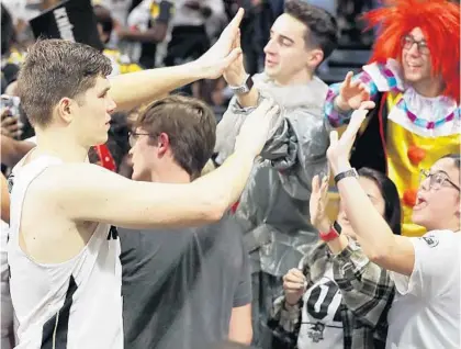  ?? STEPHEN M. DOWELL/ORLANDO SENTINEL PHOTOS ?? UCF guard Matt Milon greets fans following the Knights’ 59-57 loss to Memphis on Jan. 29 at Addition Financial Arena.