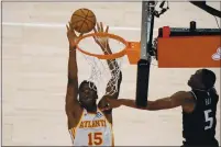  ?? BRYNN ANDERSON — THE ASSOCIATED PRESS ?? The Atlanta Hawks’ Clint Capela (15) shoots against Sacramento Kings guard De’Aaron Fox (5) in the second half Saturday in Atlanta.