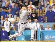  ?? Harry How Getty Images ?? NICK HUNDLEY delivers a go-ahead two-run single in the ninth inning for San Francisco.