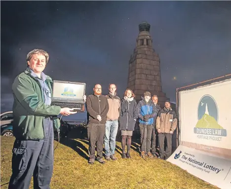  ??  ?? MEMBERS of a local history project braved the conditions to launch their new website with a screening on Dundee Law. The Law Heritage Project projected images from its site, detailing the landmark’s rich history.
Funded by the Heritage Lottery Fund,...