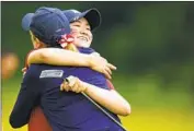  ?? Chris Szagola Associated Press ?? ROSE ZHANG, right, hugs U.S. coach Sarah LeBrun Ingram after clinching her match at the Curtis Cup.