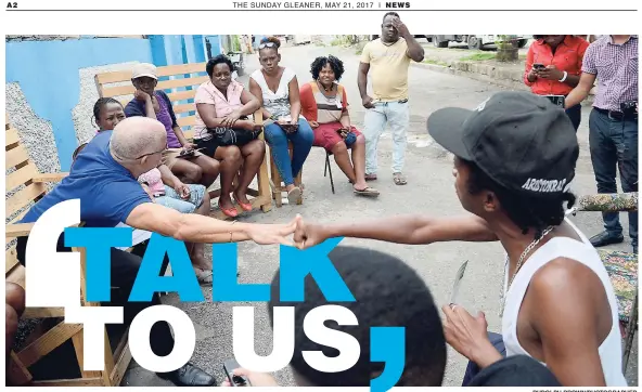  ?? RUDOLPH BROWN/PHOTOGRAPH­ER ?? Swallowfie­ld resident Corey (right) was so impressed by a comment from co-chairman of the Economic Programme Oversight Committee, Keith Duncan, that he had to give him a fist bump during an On the Corner session in the South East St Andrew community...