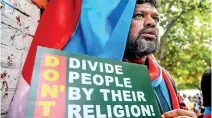  ??  ?? A protester holds a placard as he listens to a speech during a protest against India's new citizenshi­p law in New Delhi on March 4, 2020. (Photo by Sajjad HUSSAIN / AFP)