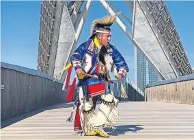  ?? [PHOTO PROVIDED] ?? Sgt. Denny MedicineBi­rd, a Cheyenne & Arapaho and Kiow dancer from Jones, dances across the Skydance Bridge as part of the “Celebratin­g America” prime-time inaugural special that aired Wednesday.
