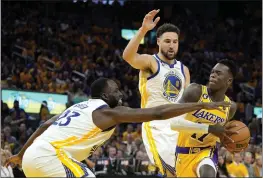  ?? THEARON W. HENDERSON — GETTY IMAGES, FILE ?? The Lakers' Dennis Schroder (17) drives to the basket against the Warriors' Draymond Green (23) and Klay Thompson (11) during the second quarter of Game 5of a Western Conference semifinal at Chase Center last Wednesday in San Francisco.