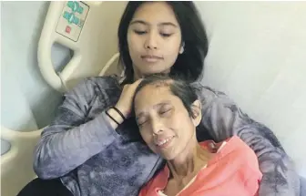  ??  ?? Mara Soriano, top, holds her mother, Marilyn, in the hospital in a family photo. Marilyn’s voice lives on in the teddy bear that was returned to Mara on Tuesday night.