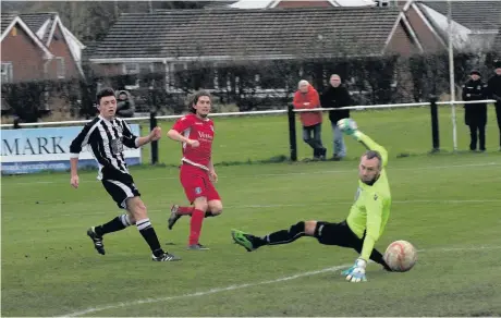  ?? Paul Watson ?? Joe Holt ( right) opens the scoring for Runcorn Town in their 3-0 victory over Barnton on Saturday as Chris Herbert’s team increased their advantage at the top of the table to five points.