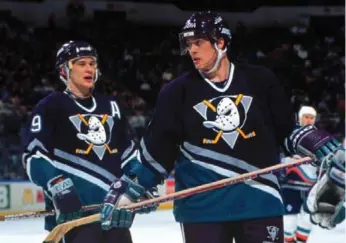 ?? BRUCE BENNETT/GETTY IMAGES ?? Teemu Selanne, right, hopes former Ducks linemate Paul Kariya returns to the sport in some capacity. Says Kariya, who retired early because of concussion­s: “I would be open. There’s really been no calls from teams.”