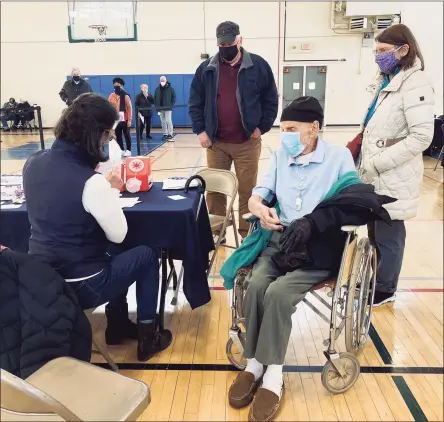  ?? Susan Shultz / Hearst Connecticu­t Media ?? Darien’s Alfred Andreoli, who will turn 103 in April, recently received his second dose of the Moderna vaccine at Darien’s vaccinatio­n clinic. His daughter Patricia and son-in-law James received their first dose.