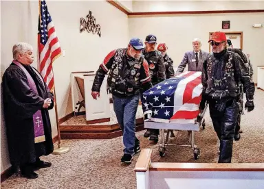  ?? [PHOTO BY CHRIS LANDSBERGE­R, THE OKLAHOMAN] ?? Members of the Patriot Guard Riders carry the casket of homeless Army veteran William Eugene Weeks Jr., 64, out of the chapel after his funeral Wednesday at Chapel Hill Funeral Home in Oklahoma City.