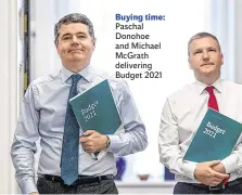  ??  ?? Buying time: Paschal Donohoe and Michael McGrath delivering Budget 2021