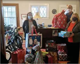  ?? SUBMITTED PHOTO ?? Benchmark Federal Credit Union President and CEO Daniel J. Machon Jr. (center) delivers gifts to Family Service of Chester County’s Amy DeFonzo and Margie Helms.