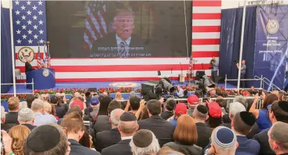  ?? (Marc Israel Sellem/The Jerusalem Post) ?? HUNDREDS OF invited guests watch a recorded video of US President Donald Trump addressing the opening ceremony for the new American Embassy in Jerusalem.