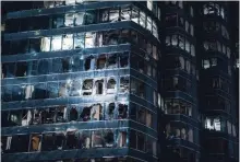  ?? LAM YIK FEI GETTY IMAGES ?? Windows broken by typhoon Mangkhut mark a commercial building in Hong Kong on Sunday.