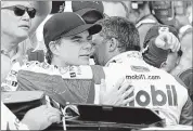  ?? ROB BAKER/ASSOCIATED PRESS ?? Jeff Gordon (left) hugs Tony Stewart following July’s Brickyard 400 NASCAR Sprint Cup race at Indianapol­is. Both drivers, fan favorites for years, are winding down their careers.