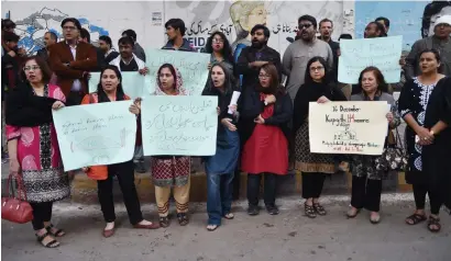  ?? AFP ?? Rights activists commemorat­e the third anniversar­y of the Army Public School massacre at an event in Karachi on Saturday. —