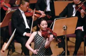  ?? PROVIDED TO CHINA DAILY ?? Japanese violinist Mayu Kishima performs during the Isaac Stern competitio­n in Shanghai. Kishima walked away with the top prize of US$100,000.