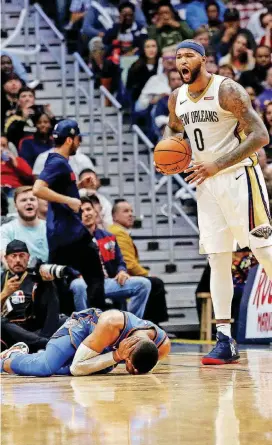  ??  ?? Pelicans center DeMarcus Cousins, right, said the Thunder’s Russell Westbrook “did a good job of selling” a flagrant foul in the teams’ game Monday by laying on the floor after the contact.