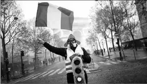  ??  ?? A protestor with the flag from France. (Photo: CNN Internatio­nal)