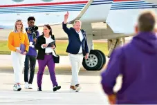  ?? AP Photo/Matthew Hinton ?? ■ New LSU football coach Brian Kelly gestures to fans after his arrival at Baton Rouge Metropolit­an Airport on Nov. 30 in Baton Rouge, La. Kelly, formerly of Notre Dame, is said to have agreed to a 10-year contract with LSU worth $95 million plus incentives.