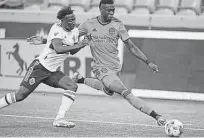  ?? Rick Bowmer / Associated Press ?? Centerback Teenage Hadebe, right, made his Dynamo debut in Tuesday’s draw with Janio Bikel and the Vancouver Whitecaps.