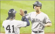  ?? Mitchell Layton / Getty Images ?? The Yankees’ Greg Bird celebrates a home run in the fifth inning with Miguel Andujar against the Orioles on Tuesday night in Baltimore.