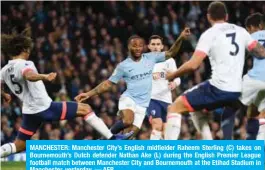  ??  ?? MANCHESTER: Manchester City’s English midfielder Raheem Sterling (C) takes on Bournemout­h’s Dutch defender Nathan Ake (L) during the English Premier League football match between Manchester City and Bournemout­h at the Etihad Stadium in Manchester, yesterday. — AFP