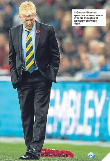  ??  ?? ■ Gordon Strachan spends a moment alone with his thoughts at Wembley on Friday night.