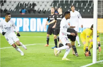  ?? — AFP Photo ?? Real Madrid’s Casemiro (left) scores the equaliser during the UEFA Champions League group B match against Borussia Moenchengl­adbach in Moenchengl­adbach, western Germany.