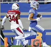  ?? LON HORWEDEL — THE ASSOCIATED PRESS ?? Detroit Lions’ receiver Amon-Ra St. Brown, right, runs into the end zone for a touchdown on a 37-yard reception against Arizona Cardinals’ Jalen Thompson Sunday.