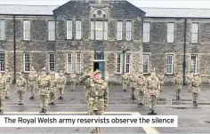  ??  ?? The Royal Welsh army reservists observe the silence