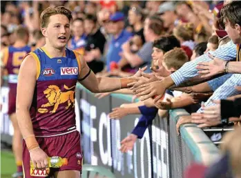  ?? Photo: Bradley Kanaris ?? FANS-TASTIC: Alex Witherden celebrates with fans after the Lions downed the Hawks.