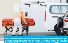  ??  ?? SANTIAGO: Employees of a funeral parlour put the coffin containing the body of a person who died of COVID-19 in the vehicle of a relative, outside the San Jose Hospital in Santiago amid the novel coronaviru­s pandemic. — AFP