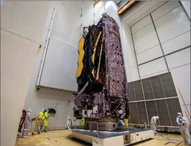  ?? (File Photo/AP/ESA/M.Pedoussaut) ?? NASA’s James Webb Space Telescope is secured Dec. 11, 2021, on top of the Ariane 5 rocket that will launch it to space from Europe’s Spaceport in French Guiana.