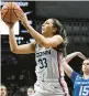  ?? JESSICA HILL/AP ?? Uconn’s Caroline Ducharme shoots over the Creighton defense Wednesday in Storrs.