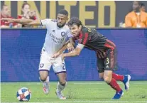  ?? DALE ZANINE/USA TODAY SPORTS ?? Orlando City defender Ruan (2) and Atlanta United defender Michael Parkhurst (3) battle for the ball earlier this season at Mercedes-Benz Stadium.