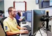  ?? BY ANYA MAGNUSON, THE OKLAHOMAN] [PHOTO ?? Ryan Fucheck, a general forecaster at Weather Decision Technologi­es, works at his desk in Norman on Monday. The private company is helping forecast precipitat­ion in the area where a team of Thai soccer players was recently stranded in a cave that is now underwater.