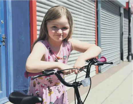  ??  ?? Kasie Williams had her bike stolen from Aldi, so staff there paid to buy her a new one. Picture by Stu Norton.