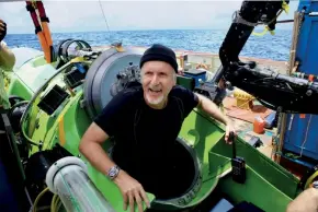  ??  ?? James Cameron emerging from the Deepsea Challenger after the solo dive