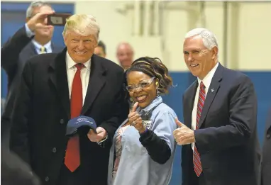  ?? TIMOTHYA. CLARY/GETTY IMAGES ?? President-elect Donald Trump and Vice President-elect Mike Pence, right, visit the Carrier air conditioni­ng and heating company Thursday in Indianapol­is. Trump took credit for the company’s decision to keep the plant open.