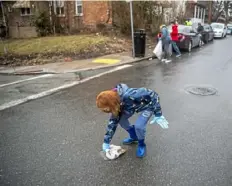  ??  ?? Sheraden Neighbor Dyana Kroger helps clean up the streets.