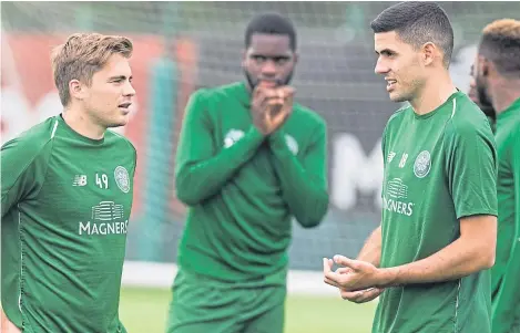  ?? Picture: SNS. ?? James Forrest and Tom Rogic take a break during Celtic training at Lennoxtown.
