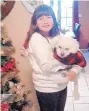  ?? COURTESY OF LYDIA DAUGHTRY ?? Adely Bazan, 11, stands next to the family’s Christmas tree with Peluchin before the burglary.