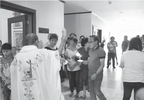  ?? CONTRIBUTE­D PHOTO ?? Rev. Father Jonas Mejares blesses the newly renovated office of Talisay City Mayor Eduardo Gullas.